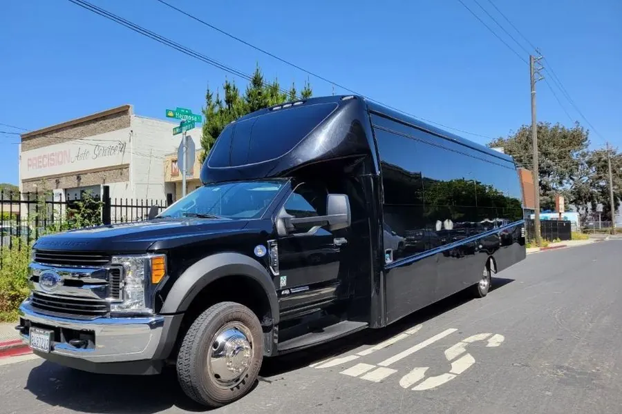 Black Ford F550 minibus owned by Umbrella Global Bus parked at the South San Francisco yard